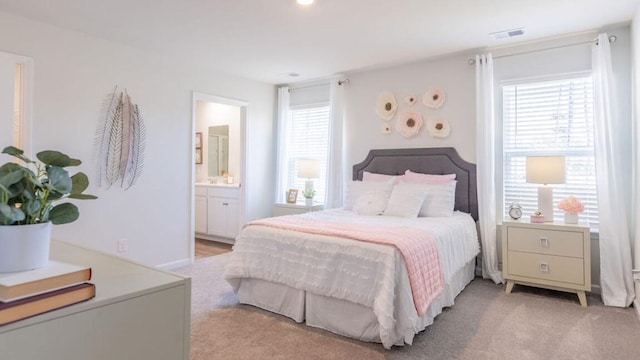 carpeted bedroom with connected bathroom