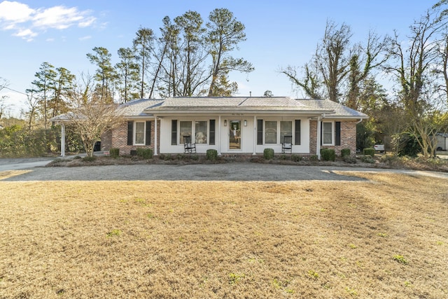 single story home with covered porch and a front lawn