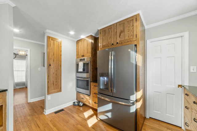 kitchen featuring light hardwood / wood-style flooring, ornamental molding, and appliances with stainless steel finishes