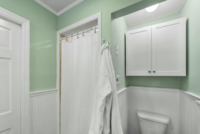 bathroom featuring toilet and ornamental molding