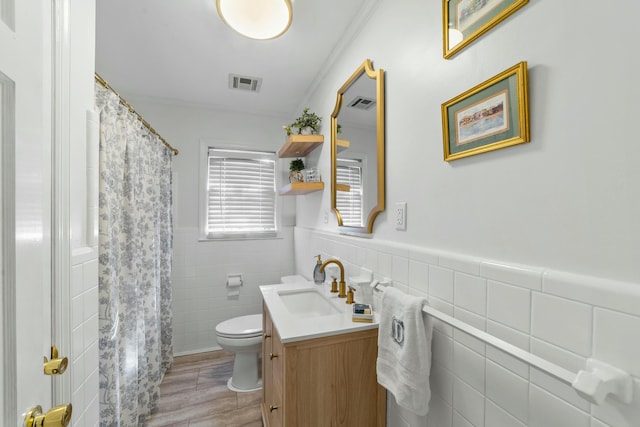 bathroom featuring vanity, a shower with curtain, toilet, tile walls, and wood-type flooring