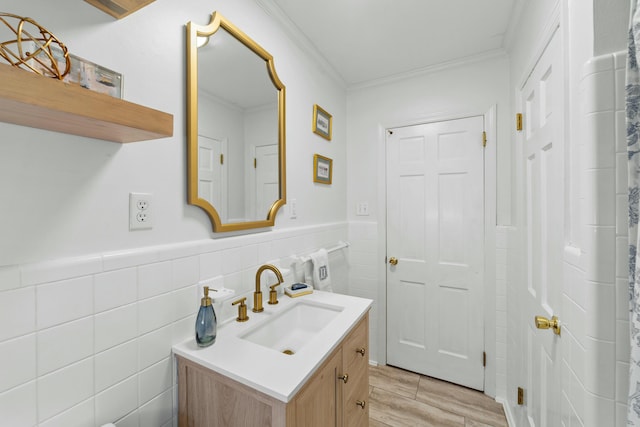 bathroom featuring vanity, tile walls, and ornamental molding