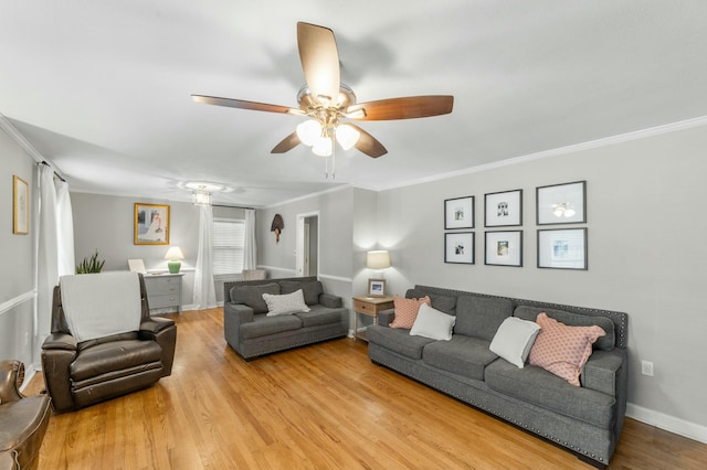 living room with ceiling fan, light wood-type flooring, and ornamental molding