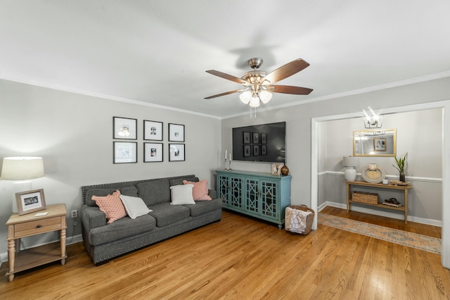 living room with hardwood / wood-style floors, ceiling fan, and ornamental molding