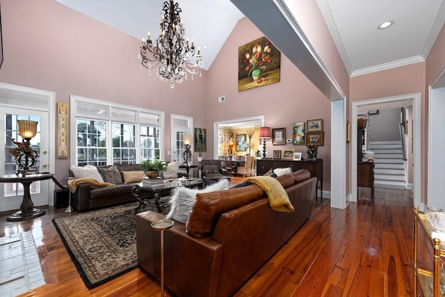 living room featuring a notable chandelier, crown molding, dark hardwood / wood-style floors, and a towering ceiling