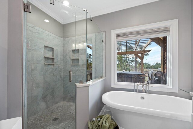 bathroom with shower with separate bathtub and ornamental molding