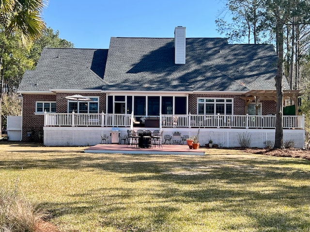 back of property featuring a lawn, a patio area, and a wooden deck