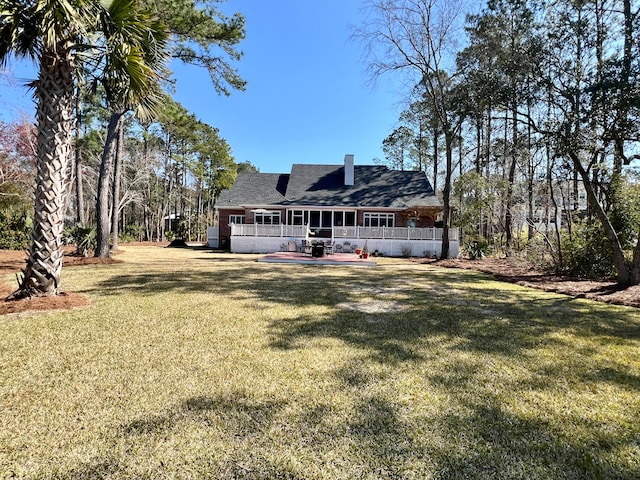 rear view of property featuring a yard