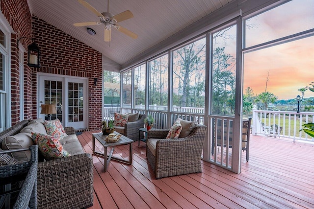 sunroom / solarium featuring ceiling fan and vaulted ceiling