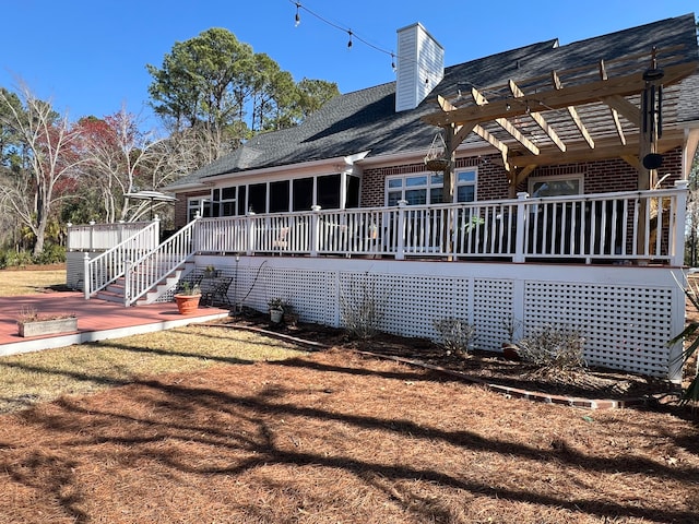 view of side of home with a pergola and a wooden deck