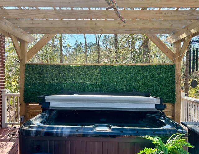 view of patio / terrace featuring a deck, a pergola, and a hot tub