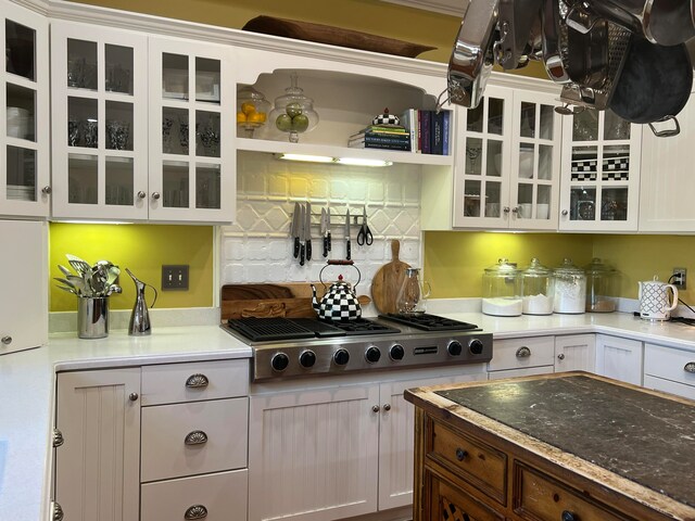 kitchen with white cabinetry, tasteful backsplash, and stainless steel gas stovetop