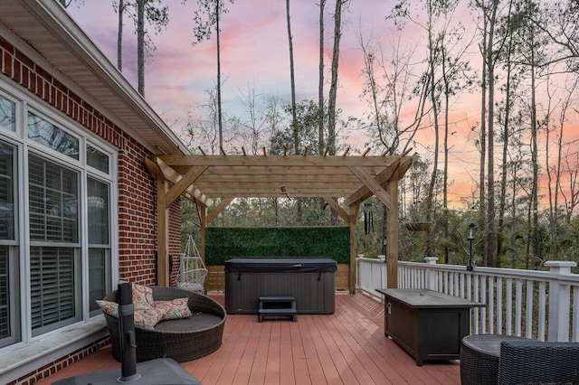 deck at dusk featuring a pergola and a hot tub