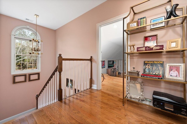 hall with hardwood / wood-style flooring