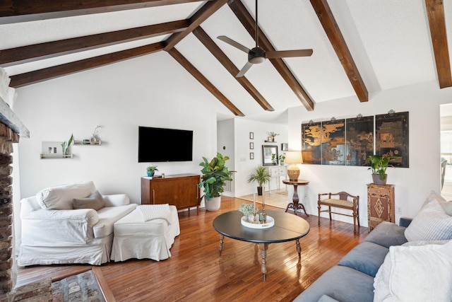 living room with beam ceiling, high vaulted ceiling, wood finished floors, and a ceiling fan