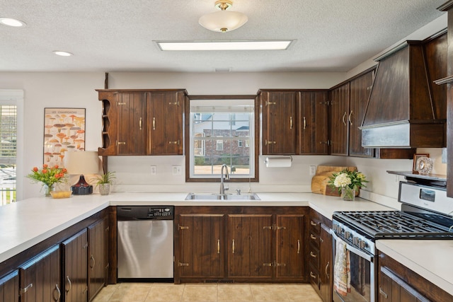 kitchen with custom exhaust hood, a sink, stainless steel appliances, light countertops, and dark brown cabinets