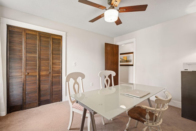 dining room featuring a ceiling fan and carpet floors