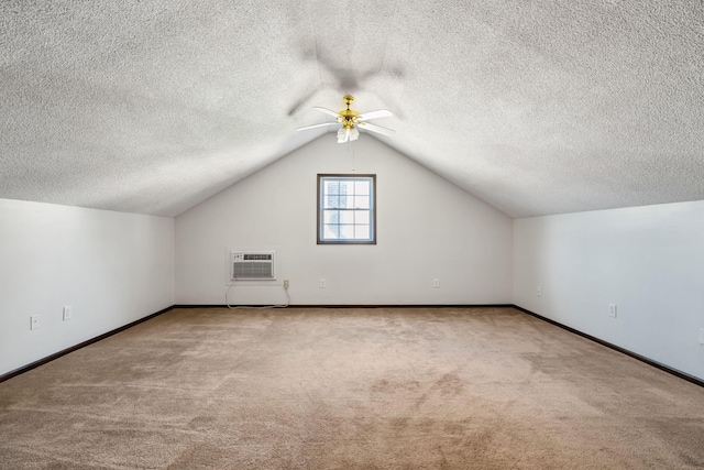 bonus room featuring lofted ceiling, a wall mounted AC, ceiling fan, and carpet floors