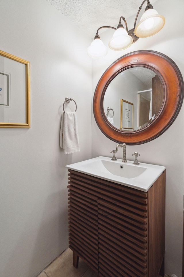 bathroom featuring vanity, tile patterned floors, and a textured ceiling