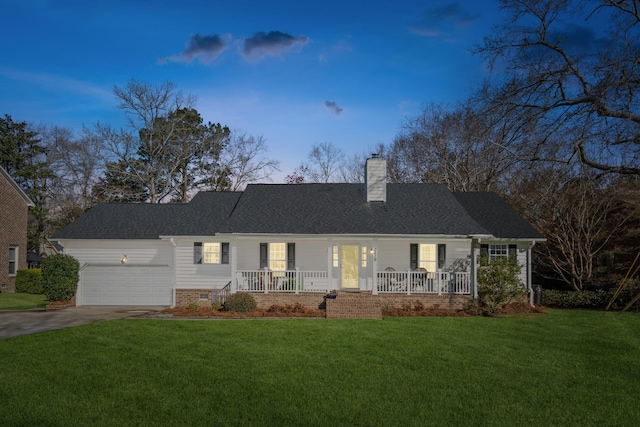 view of front of home featuring a garage, covered porch, concrete driveway, and a front yard