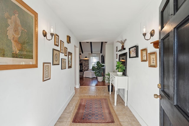 hallway with light tile patterned floors and baseboards