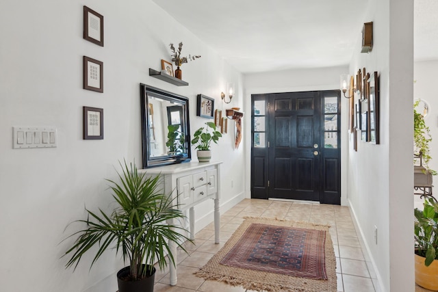 foyer featuring light tile patterned floors and baseboards