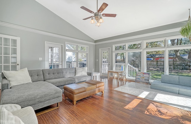 living area featuring high vaulted ceiling, hardwood / wood-style flooring, and a ceiling fan