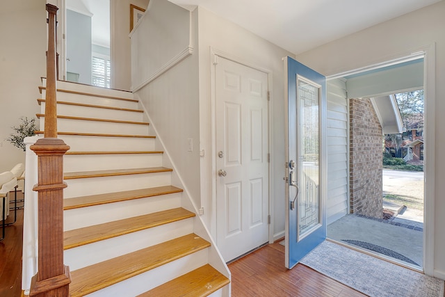 foyer featuring stairs, plenty of natural light, and wood finished floors