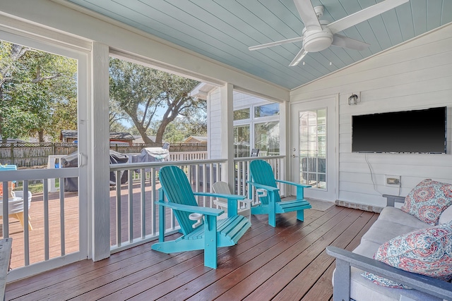 sunroom with vaulted ceiling, wood ceiling, and a ceiling fan