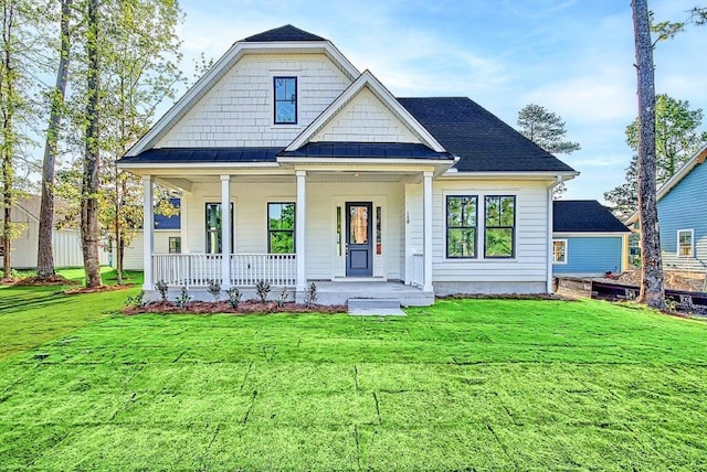 view of front of home featuring a front yard and covered porch