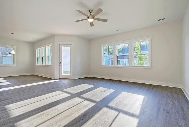 unfurnished living room with ceiling fan and dark hardwood / wood-style flooring