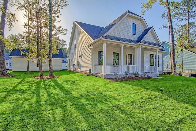 back of house with a porch and a lawn