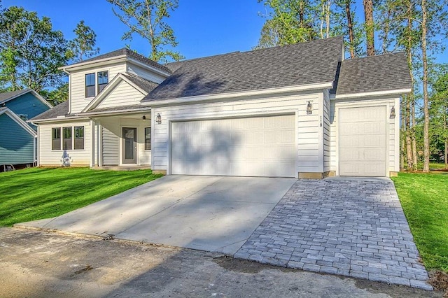 view of front of house with a front lawn and a garage