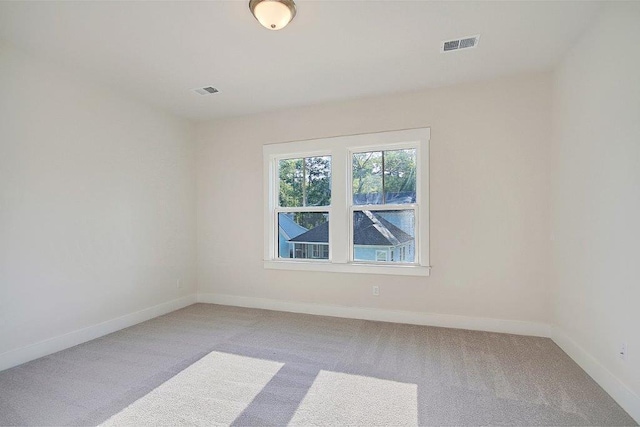 unfurnished room featuring light colored carpet