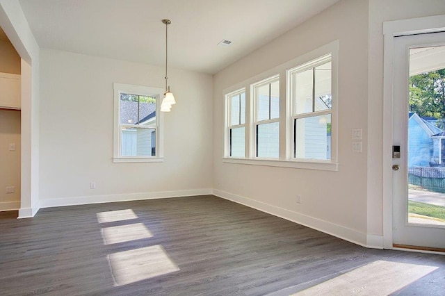 unfurnished dining area featuring dark hardwood / wood-style flooring