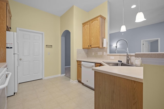 261 Sweet Alyssum Dr, Ladson, SC 29456 - kitchen featuring white appliances, a sink, arched walkways, backsplash, and light countertops