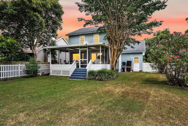 721 Lake Frances Dr, Charleston, SC 29412 - back of property at dusk featuring a sunroom, a fenced backyard, and a shingled roof