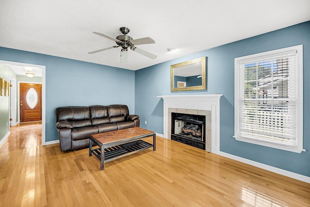 721 Lake Frances Dr, Charleston, SC 29412 - living area featuring wood-type flooring, ceiling fan, a tile fireplace, and a textured ceiling