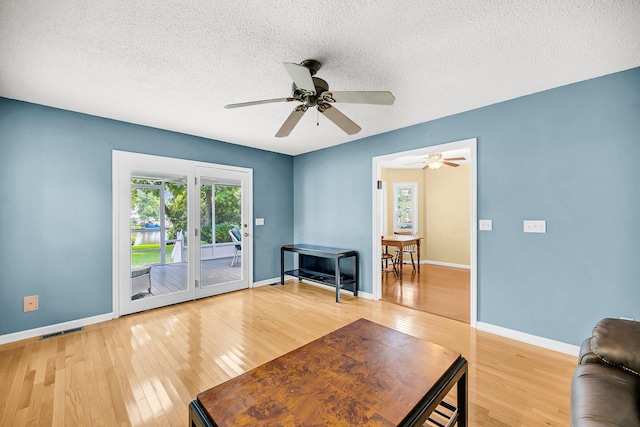 721 Lake Frances Dr, Charleston, SC 29412 - living area with light wood-type flooring, a ceiling fan, and a textured ceiling