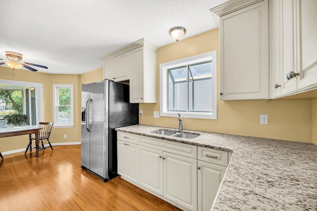 721 Lake Frances Dr, Charleston, SC 29412 - kitchen with stainless steel fridge with ice dispenser, light wood-type flooring, a ceiling fan, a textured ceiling, and white cabinets