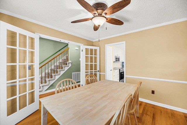 721 Lake Frances Dr, Charleston, SC 29412 - dining area with wood finished floors, a ceiling fan, ornamental molding, stairway, and french doors