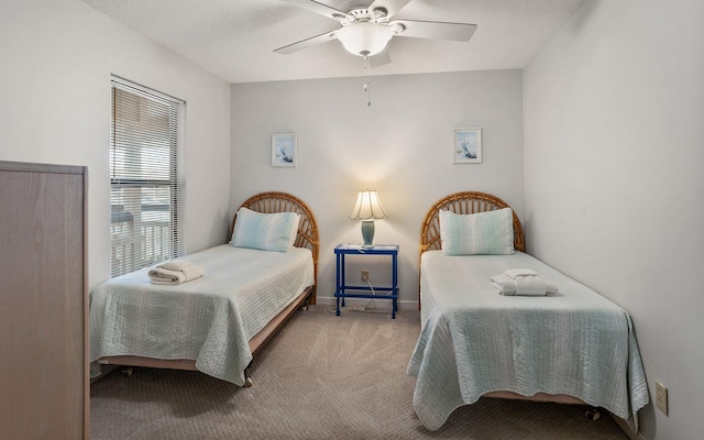 bedroom featuring carpet floors, a textured ceiling, and ceiling fan