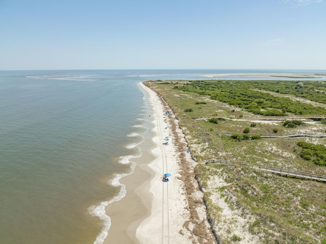 drone / aerial view featuring a water view and a beach view