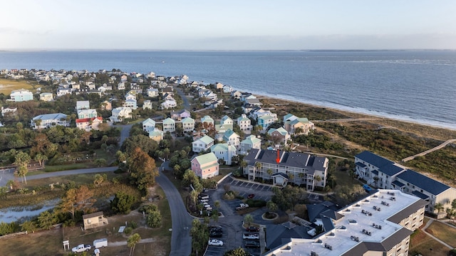 birds eye view of property with a water view and a view of the beach