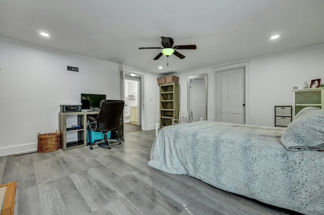 bedroom with recessed lighting, baseboards, wood finished floors, and ornamental molding