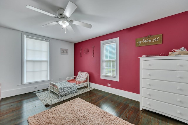 bedroom featuring ceiling fan, visible vents, baseboards, and dark wood finished floors