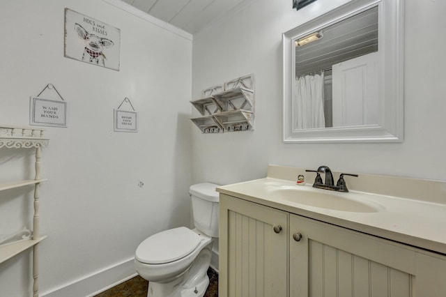 full bathroom with vanity, toilet, and baseboards