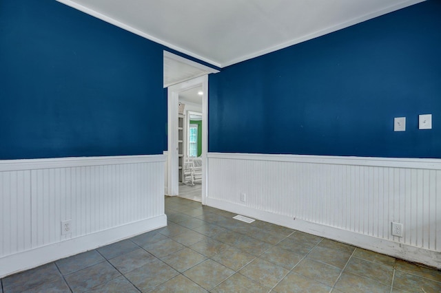 tiled spare room with wainscoting