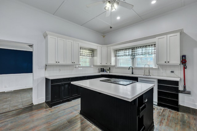 kitchen featuring wood finished floors, white cabinetry, light countertops, black electric stovetop, and dishwasher