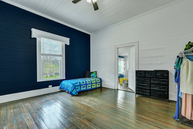 bedroom with hardwood / wood-style floors, crown molding, and a ceiling fan